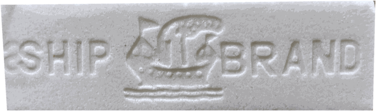 A white navsagar bar embossed Ship Brand with a sailing ship